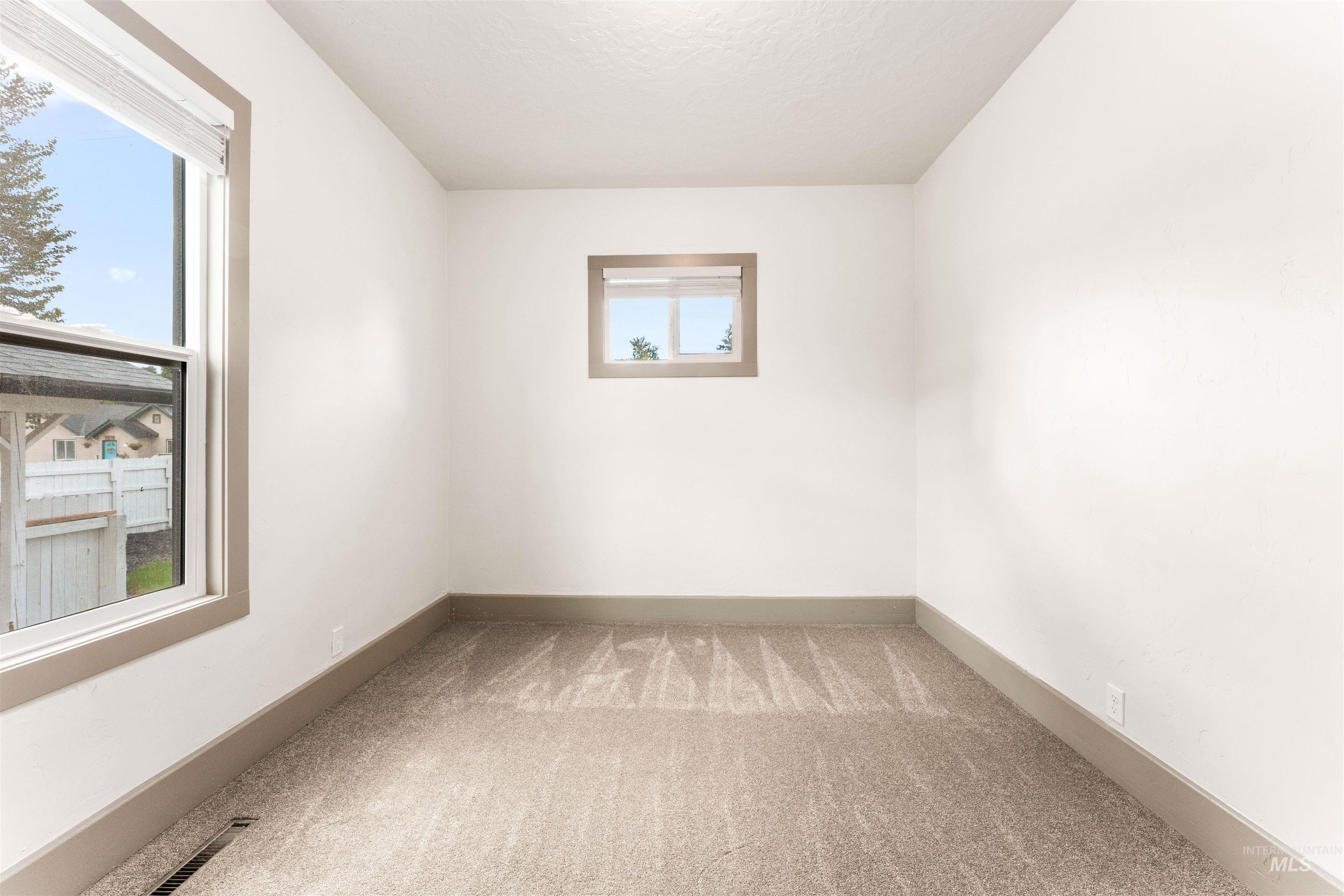 602 North 5th Street Parma, ID 83660 - Photo 32 of 48 Empty room with light carpet and baseboards