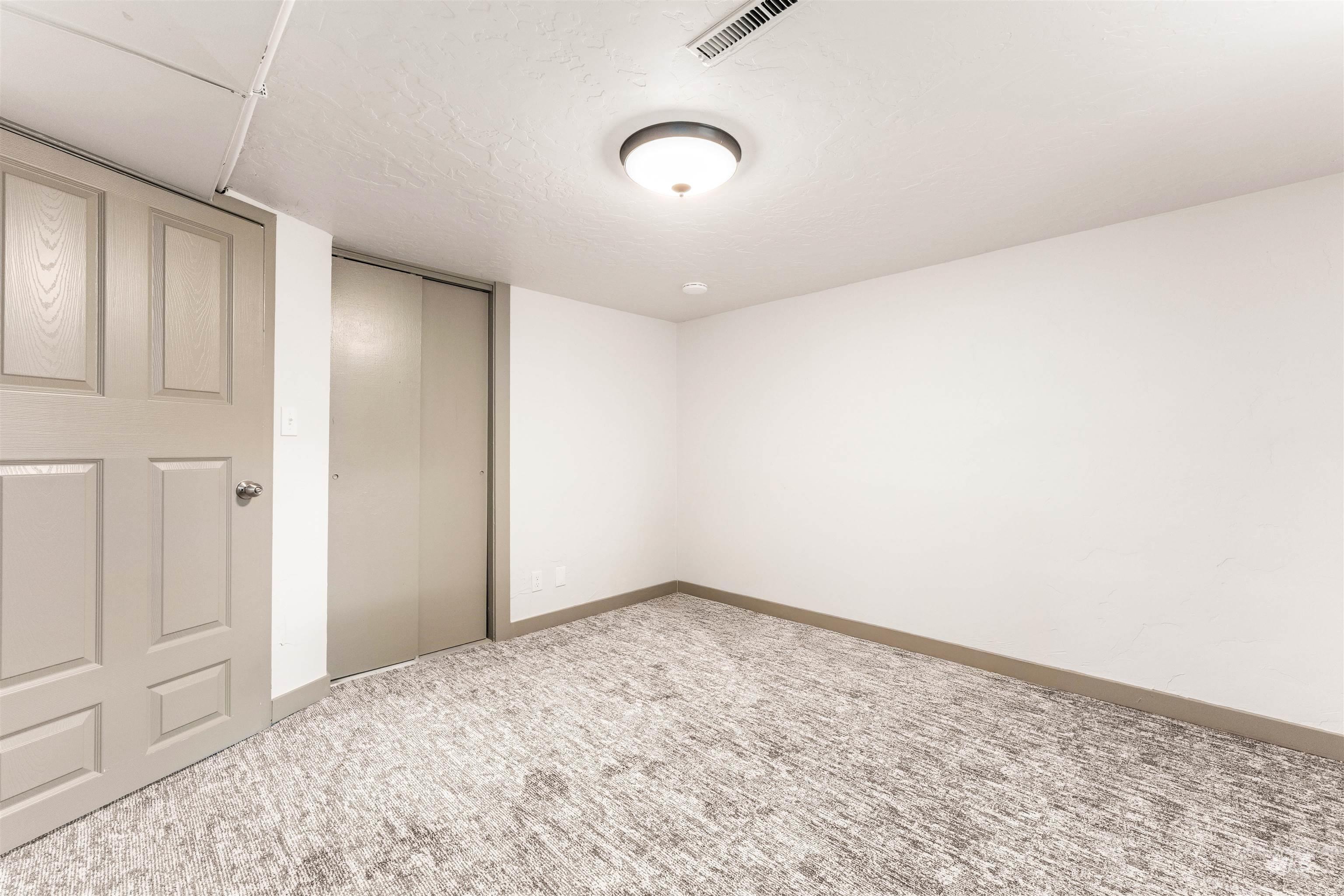 602 North 5th Street Parma, ID 83660 - Photo 39 of 48 Unfurnished bedroom with carpet floors, a closet, and a textured ceiling