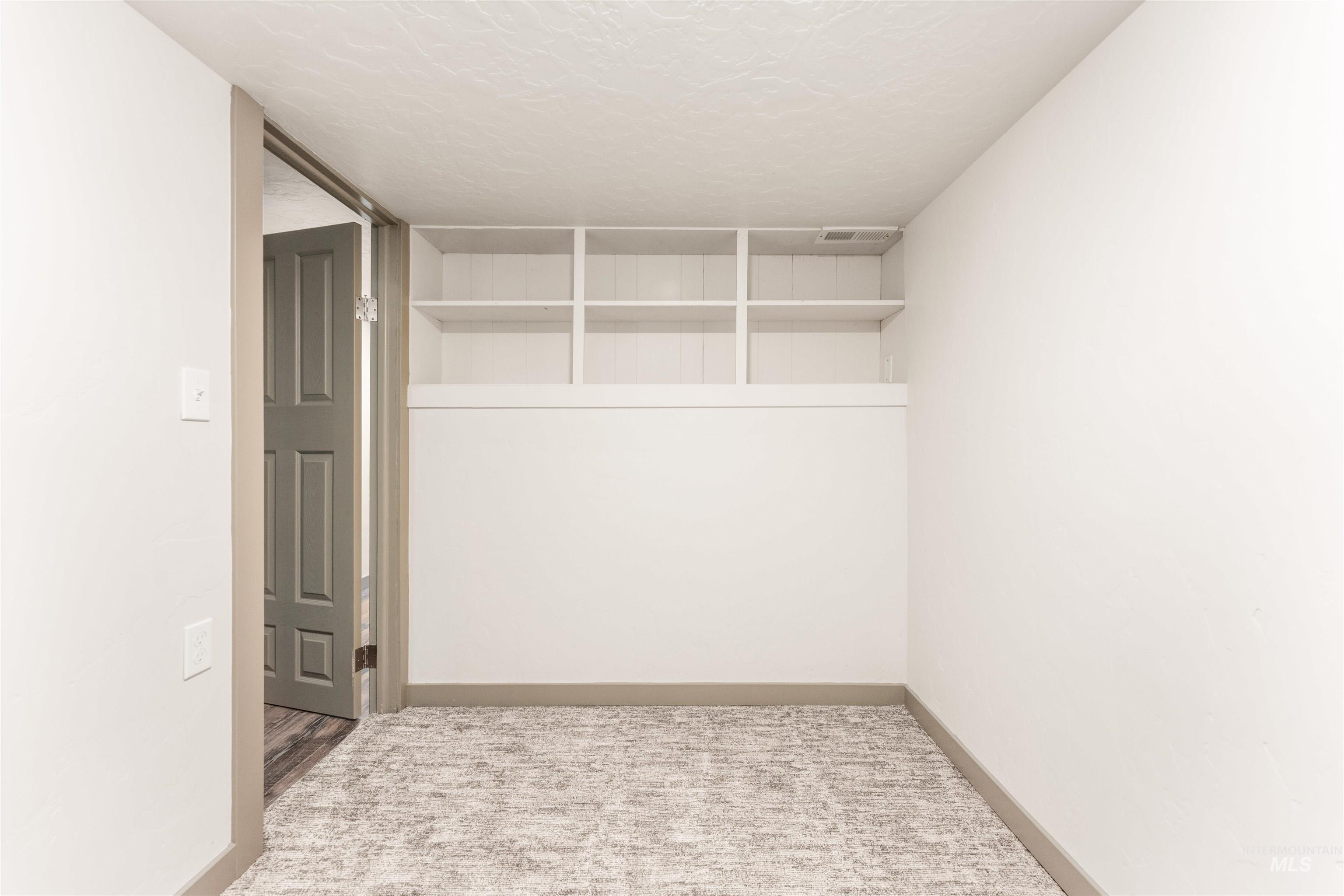 602 North 5th Street Parma, ID 83660 - Photo 42 of 48 Empty room with a textured ceiling and carpet