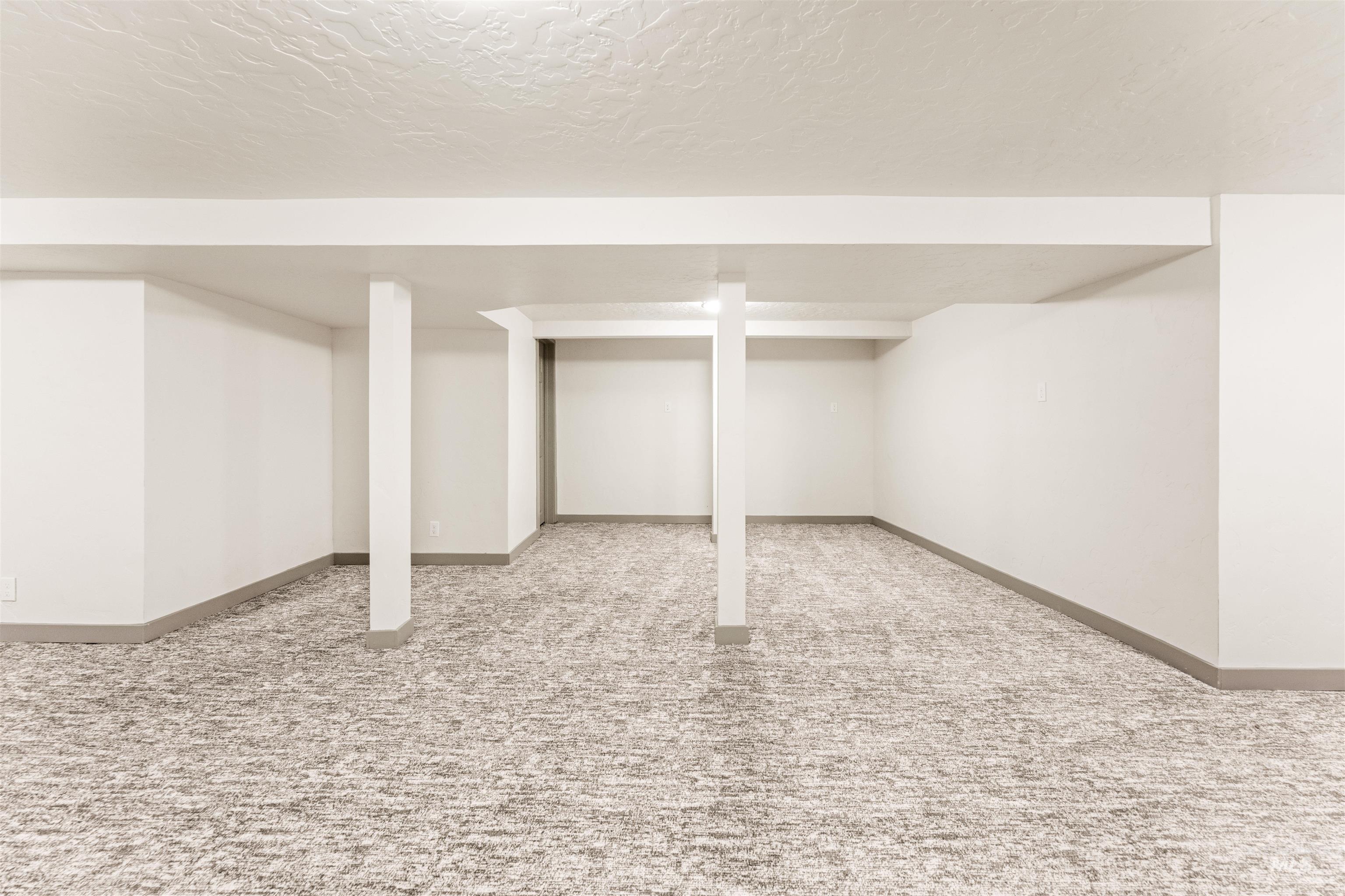 602 North 5th Street Parma, ID 83660 - Photo 45 of 48 Finished basement featuring carpet floors and a textured ceiling