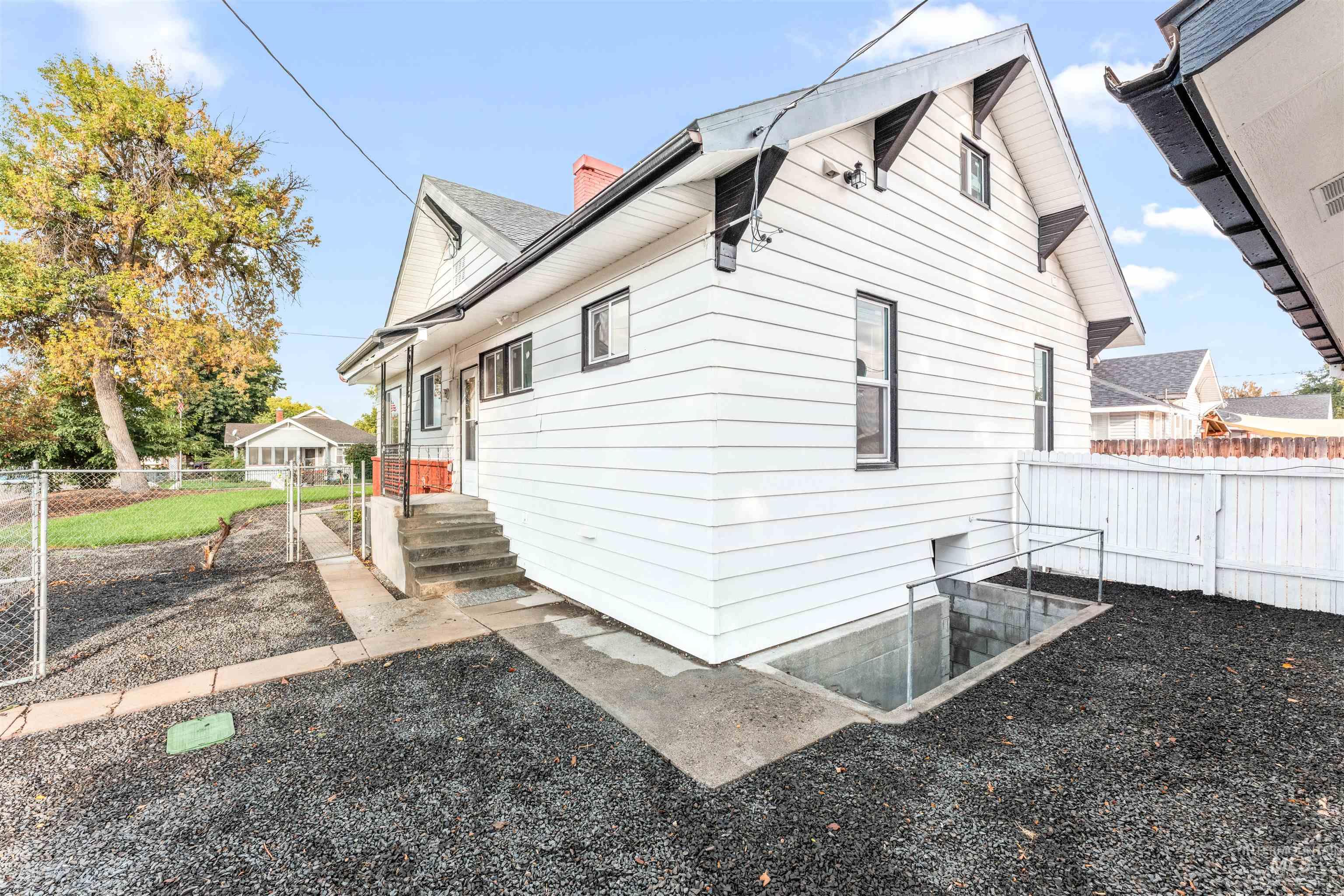 602 North 5th Street Parma, ID 83660 - Photo 10 of 48 Back of property with a gate and a chimney