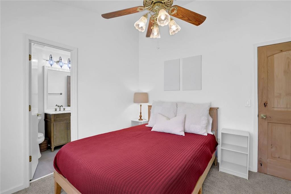 889 Fawn Way Marietta, GA 30068 - Photo 15 of 30 a bedroom with a bed and a chandelier