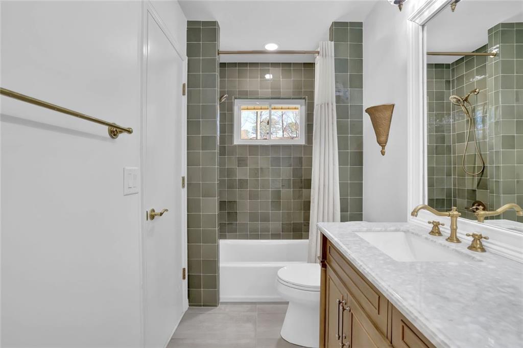 889 Fawn Way Marietta, GA 30068 - Photo 16 of 30 a bathroom with a granite countertop sink toilet and shower