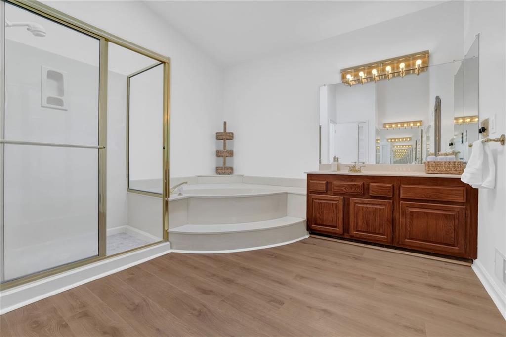 889 Fawn Way Marietta, GA 30068 - Photo 20 of 30 a bathroom with a tub sink and a mirror