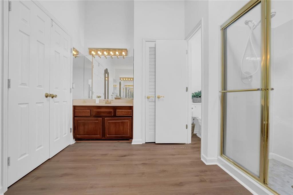 889 Fawn Way Marietta, GA 30068 - Photo 21 of 30 a view of a hallway to a bedroom with wooden floor and cabinet