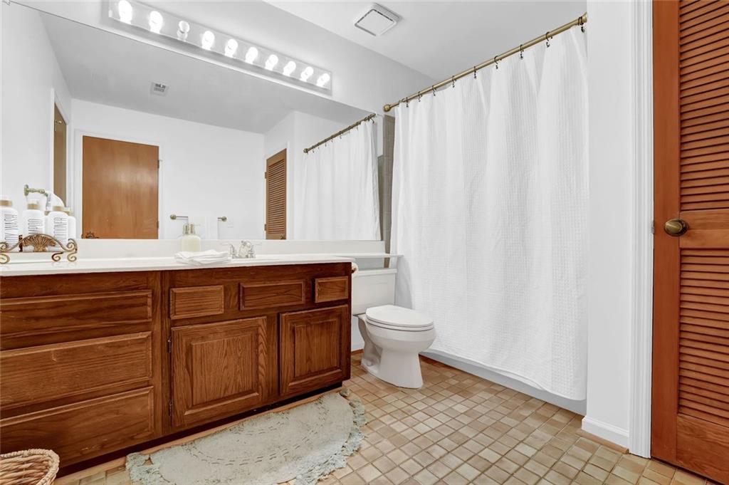 889 Fawn Way Marietta, GA 30068 - Photo 29 of 30 a bathroom with a sink a toilet and a mirror