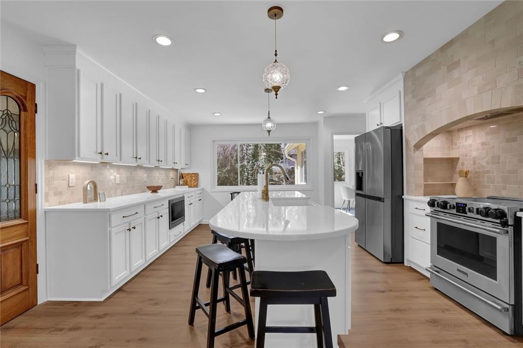 889 Fawn Way Marietta, GA 30068 - Photo 9 of 30 a large white kitchen with a sink stainless steel appliances and cabinets