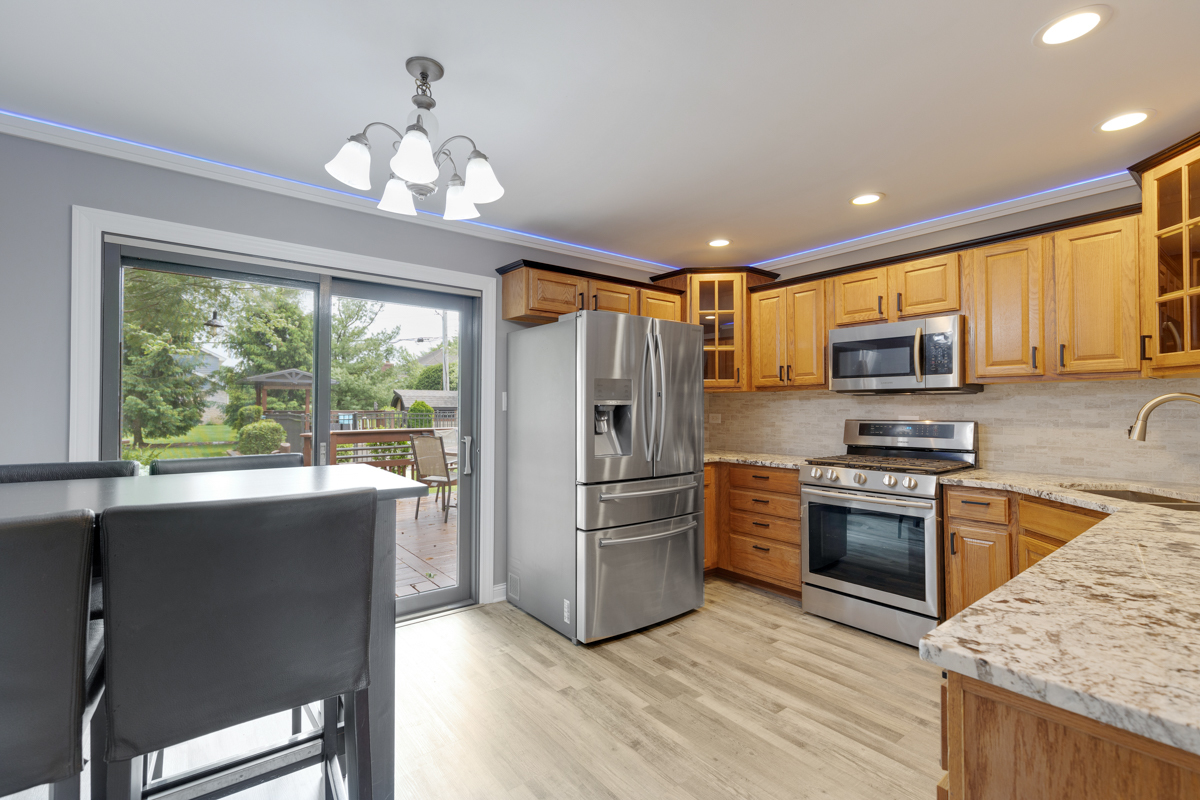 297 Mulberry Road Frankfort, IL 60423 - Photo 9 of 47 a kitchen with stainless steel appliances granite countertop a refrigerator a stove top oven a sink dishwasher and wooden cabinets