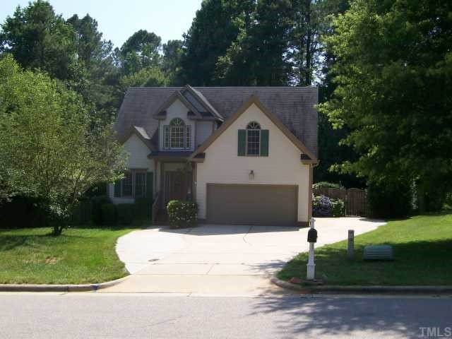 6301 Ashley Ridge Drive Raleigh, NC 27612 - Photo 1 of 12 a front view of a house with a yard and garage