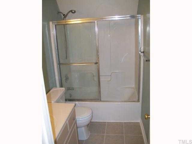 6301 Ashley Ridge Drive Raleigh, NC 27612 - Photo 11 of 12 a bathroom with a shower and a toilet