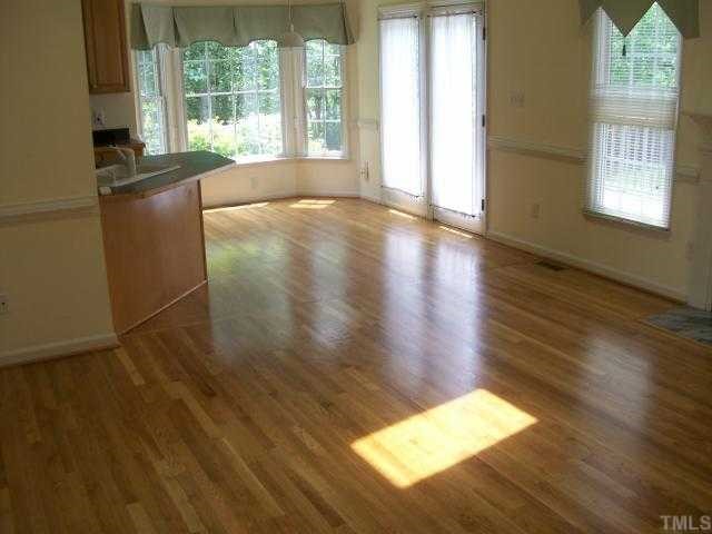 6301 Ashley Ridge Drive Raleigh, NC 27612 - Photo 12 of 12 a view of empty room with wooden floor and fan