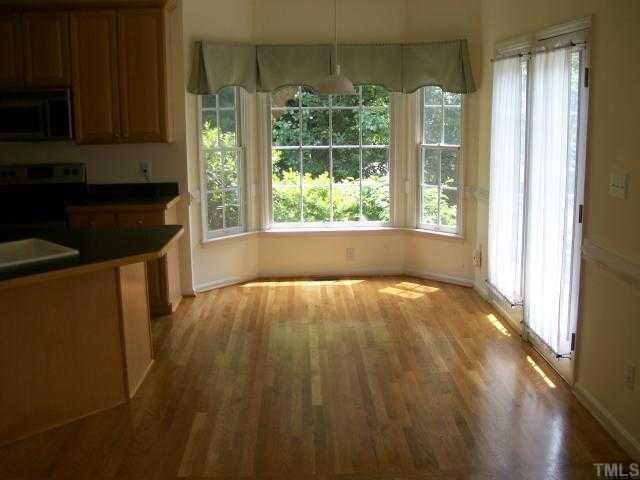 6301 Ashley Ridge Drive Raleigh, NC 27612 - Photo 5 of 12 a view of wooden floor and cabinets in a room