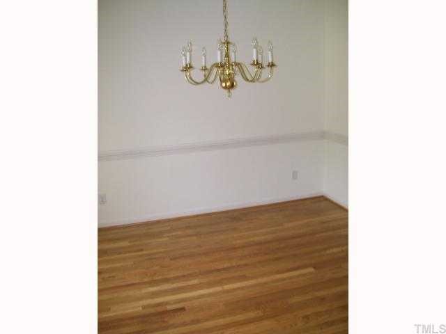 6301 Ashley Ridge Drive Raleigh, NC 27612 - Photo 7 of 12 a view of a room with a hanging light and fireplace