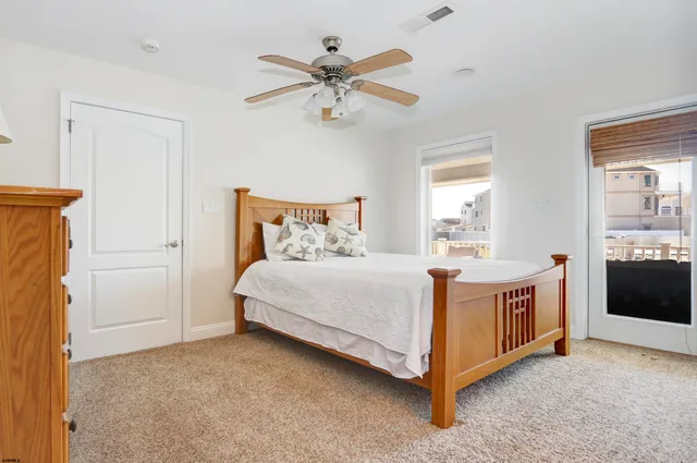 a bed room with a bed and a ceiling fan
