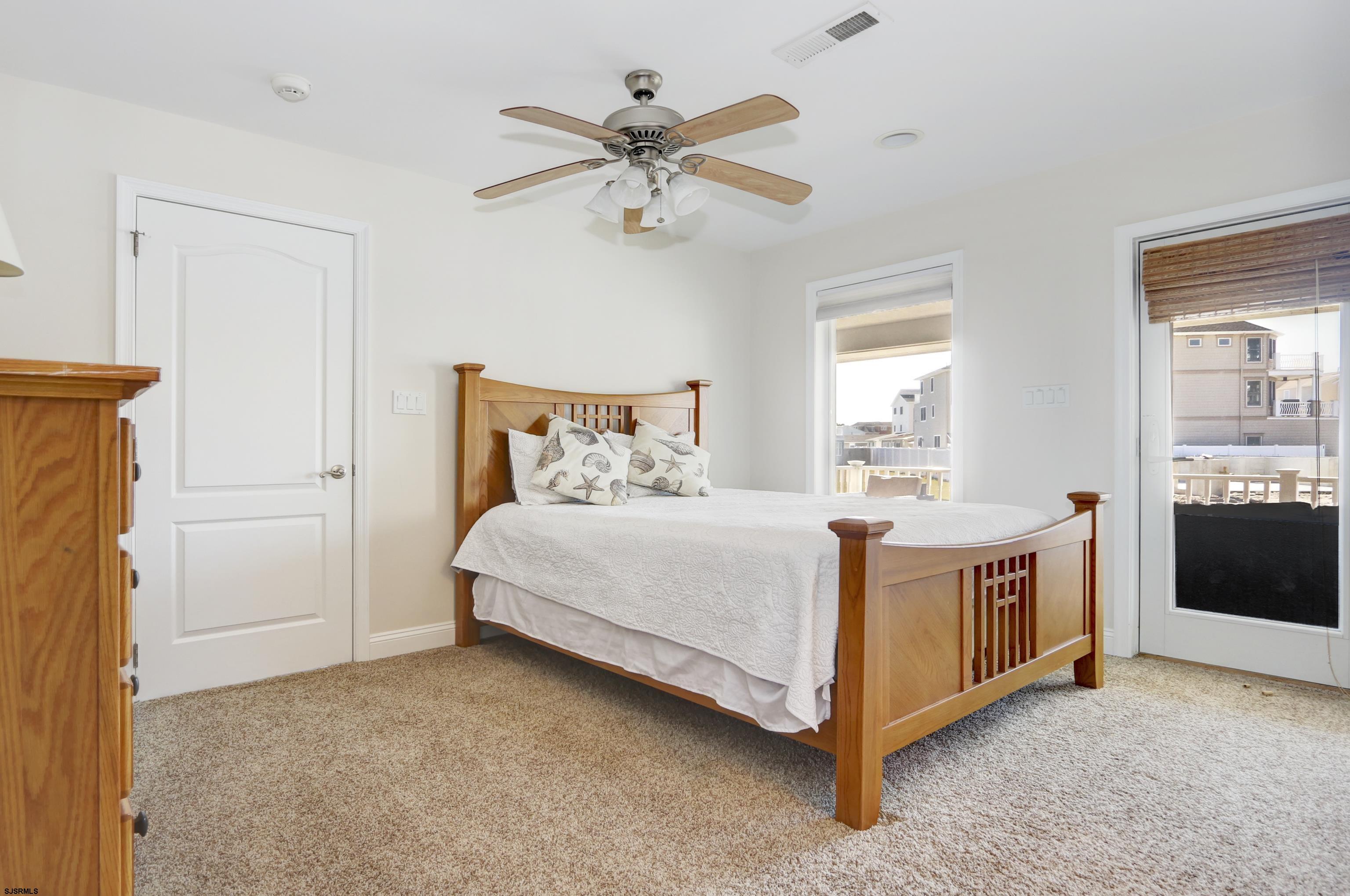 5219 Seaspray Road Brigantine, NJ 08203 - Photo 14 of 39 a bed room with a bed and a ceiling fan