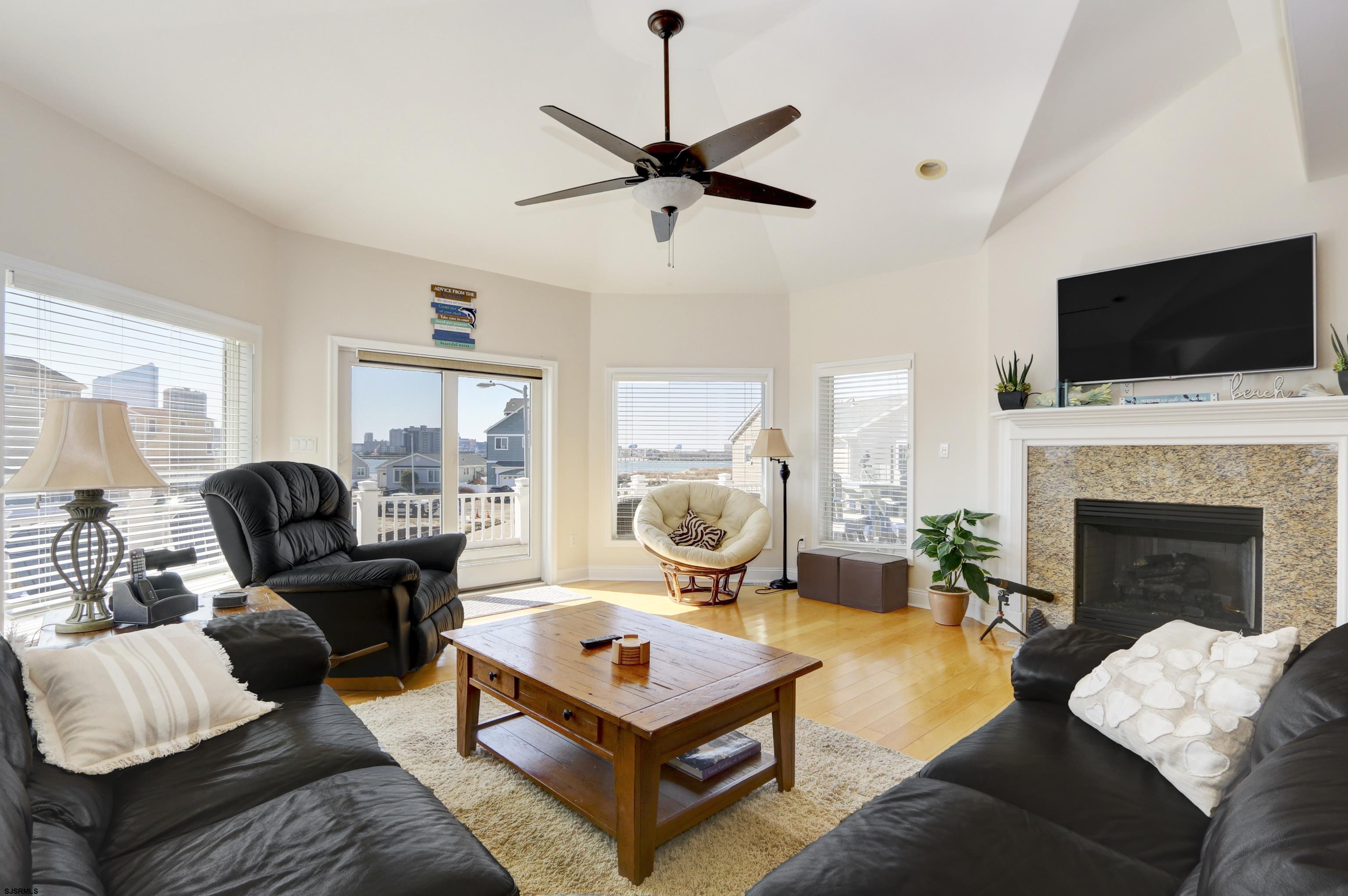 5219 Seaspray Road Brigantine, NJ 08203 - Photo 15 of 39 a living room with furniture fireplace and a flat screen tv