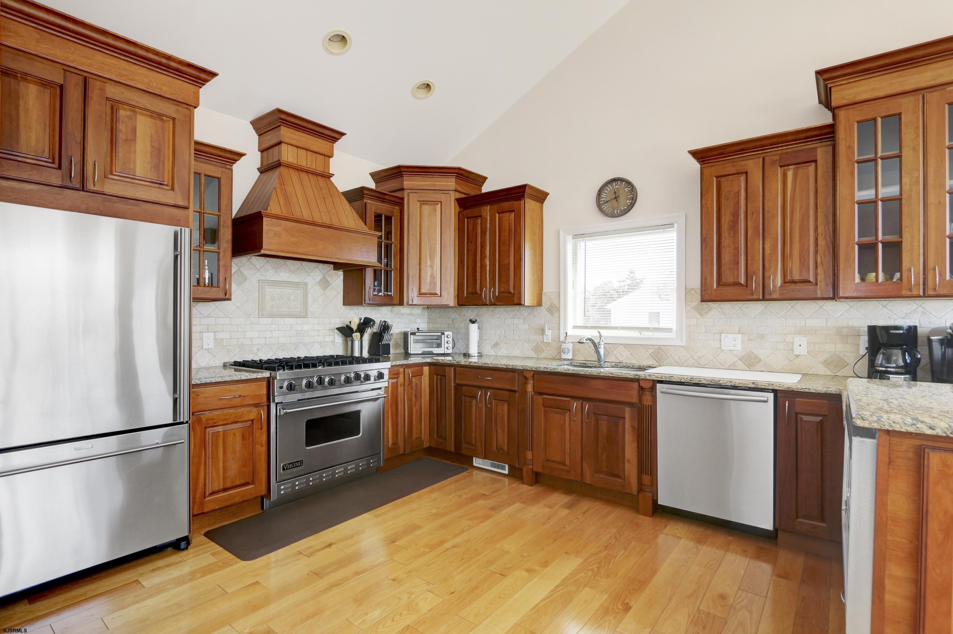5219 Seaspray Road Brigantine, NJ 08203 - Photo 20 of 39 a kitchen with stainless steel appliances granite countertop a stove a sink dishwasher and a refrigerator