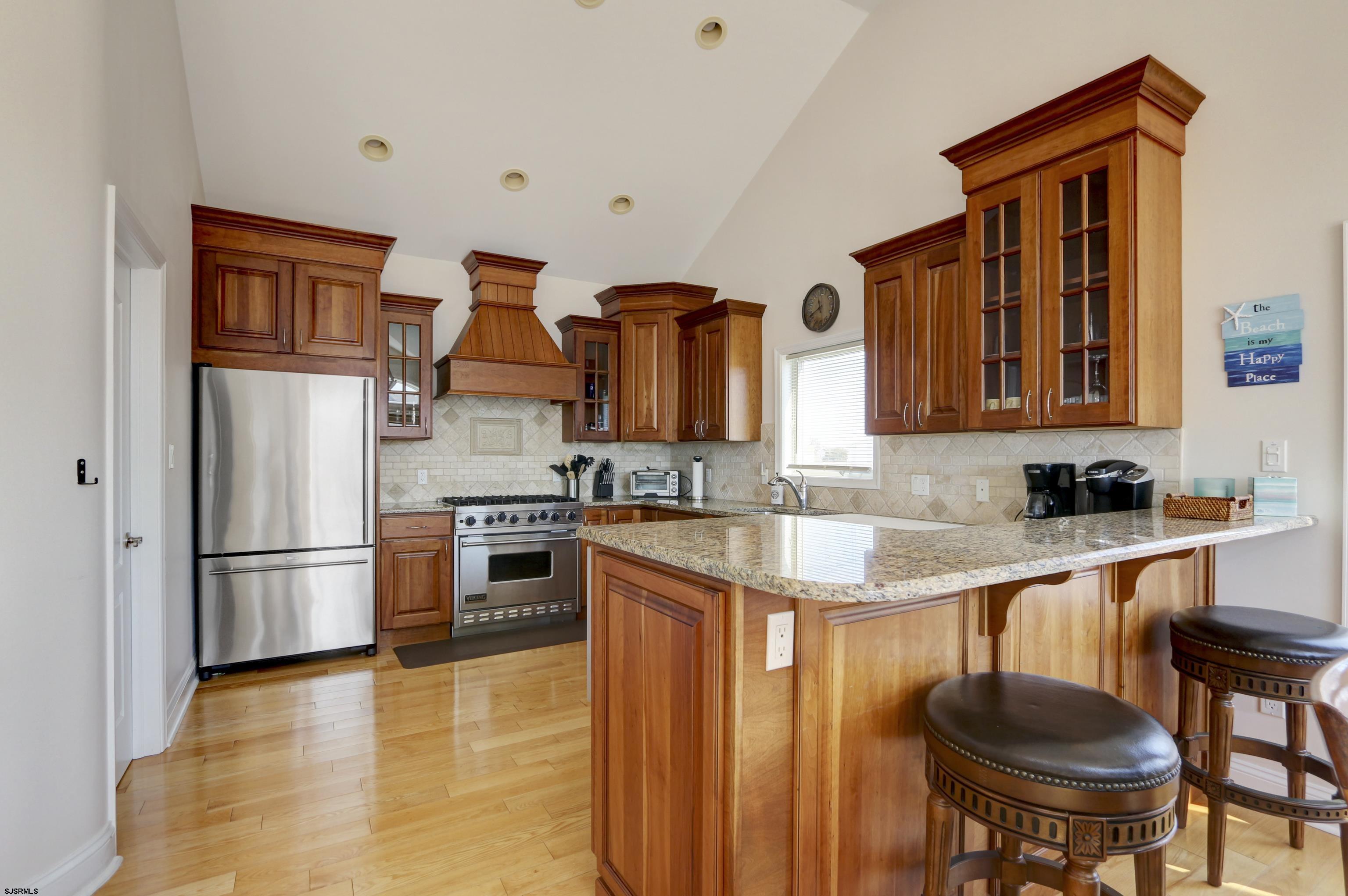 5219 Seaspray Road Brigantine, NJ 08203 - Photo 21 of 39 a kitchen with stainless steel appliances granite countertop a refrigerator and a stove top oven