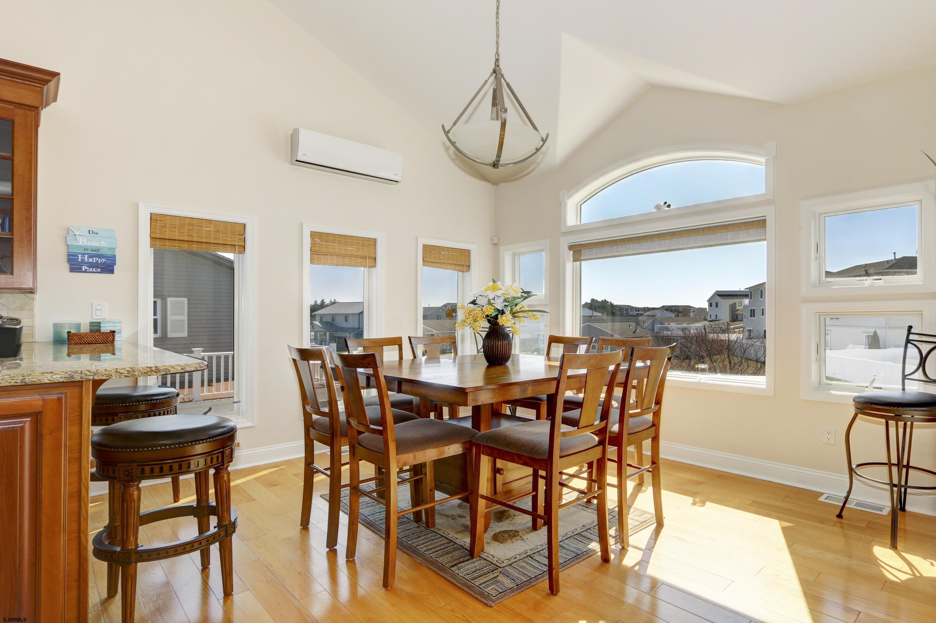 5219 Seaspray Road Brigantine, NJ 08203 - Photo 23 of 39 a view of a dining room with furniture window and wooden floor