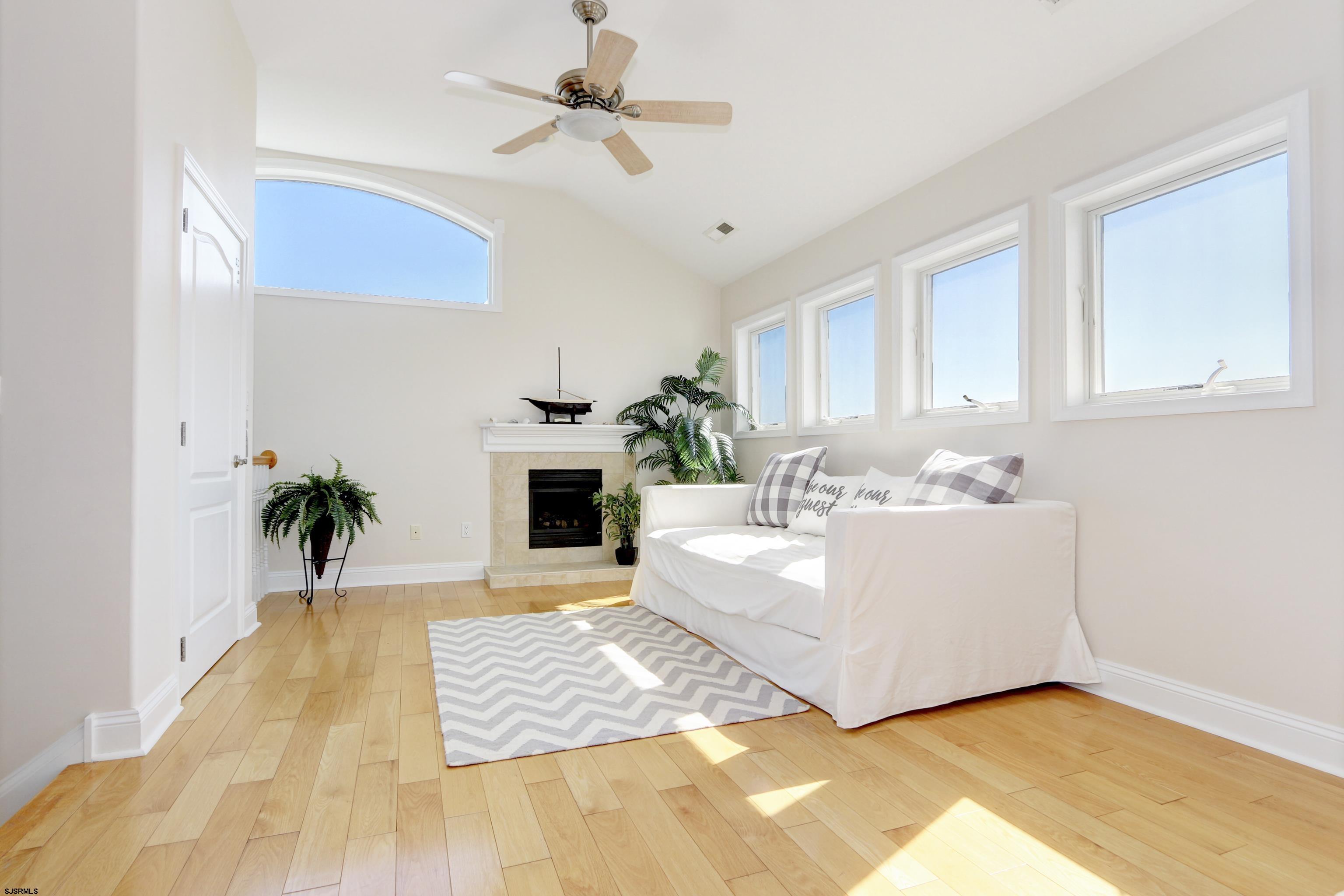 5219 Seaspray Road Brigantine, NJ 08203 - Photo 25 of 39 a living room with furniture and a fireplace