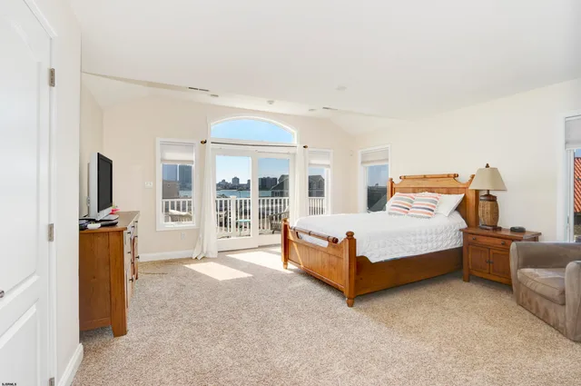 a bedroom with a bed and glass door