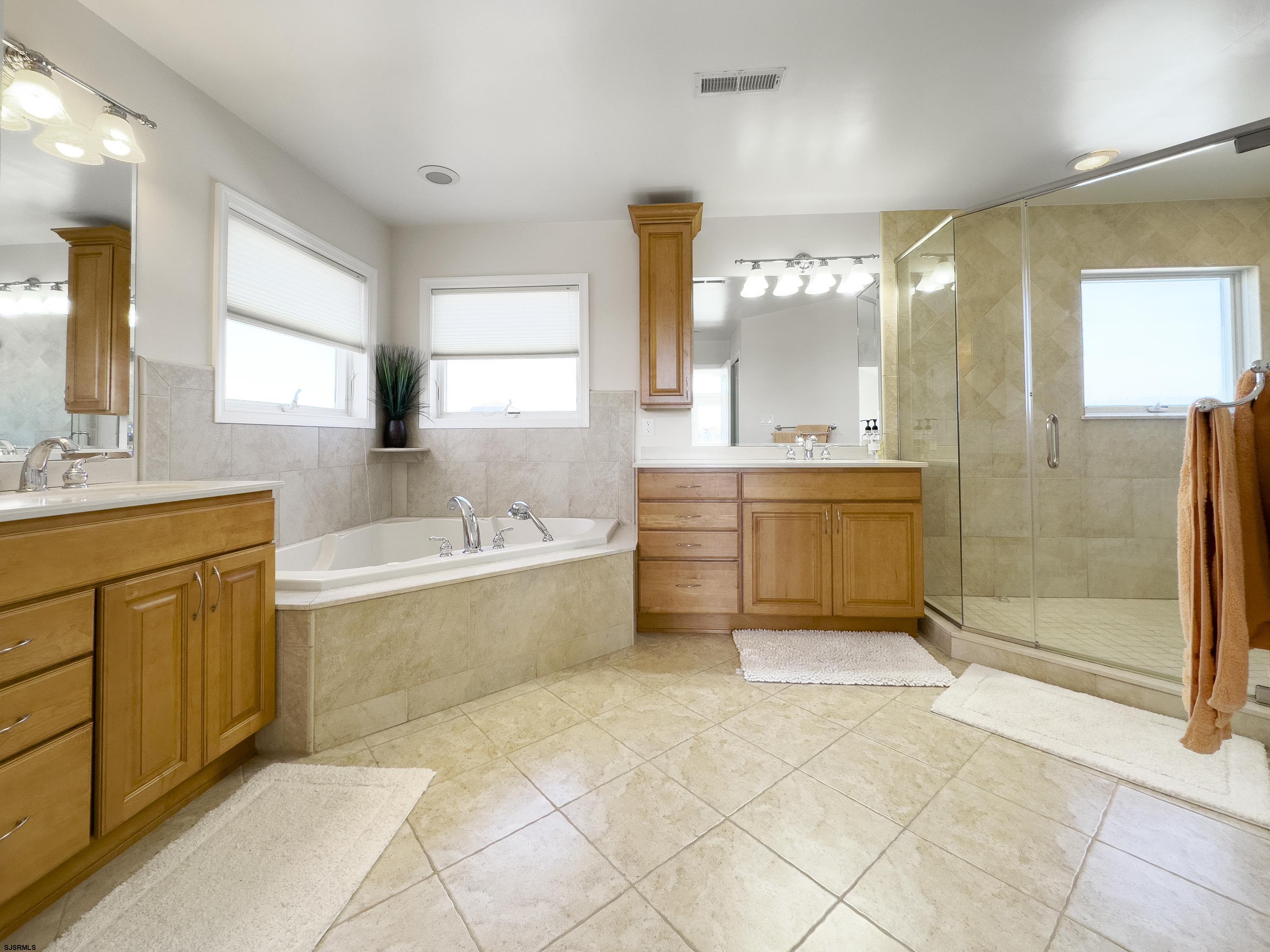 5219 Seaspray Road Brigantine, NJ 08203 - Photo 28 of 39 a spacious bathroom with a tub sink shower and mirror