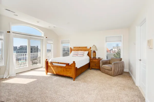 a bedroom with a bed and glass window