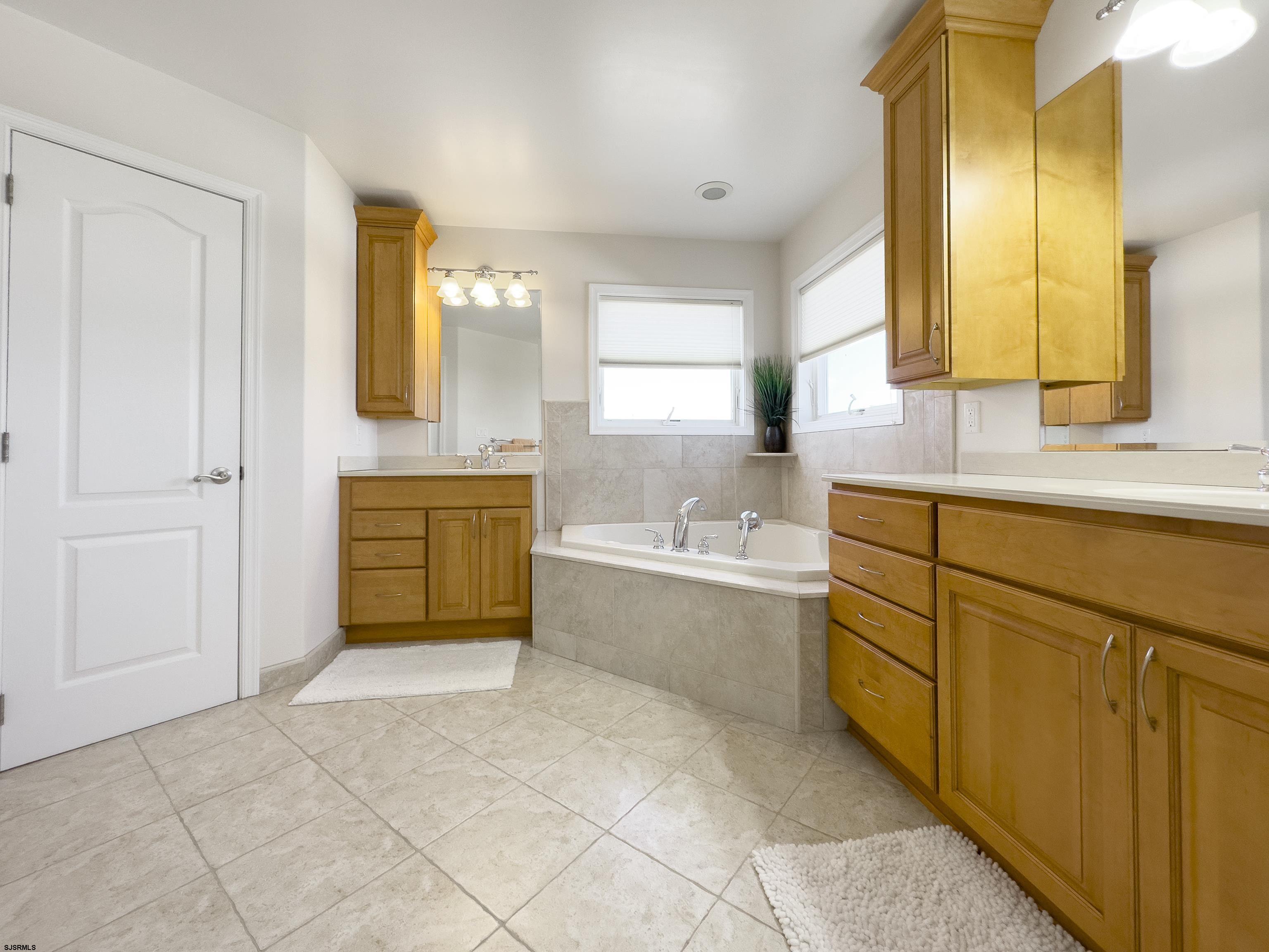 5219 Seaspray Road Brigantine, NJ 08203 - Photo 29 of 39 a bathroom with a tub sink and mirror