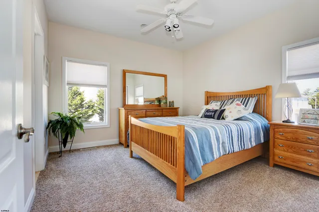 a spacious bedroom with a bed and a potted plant