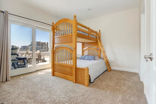 a view of a bedroom with a bed and the porch