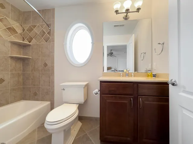 a bathroom with a sink a toilet and bathtub