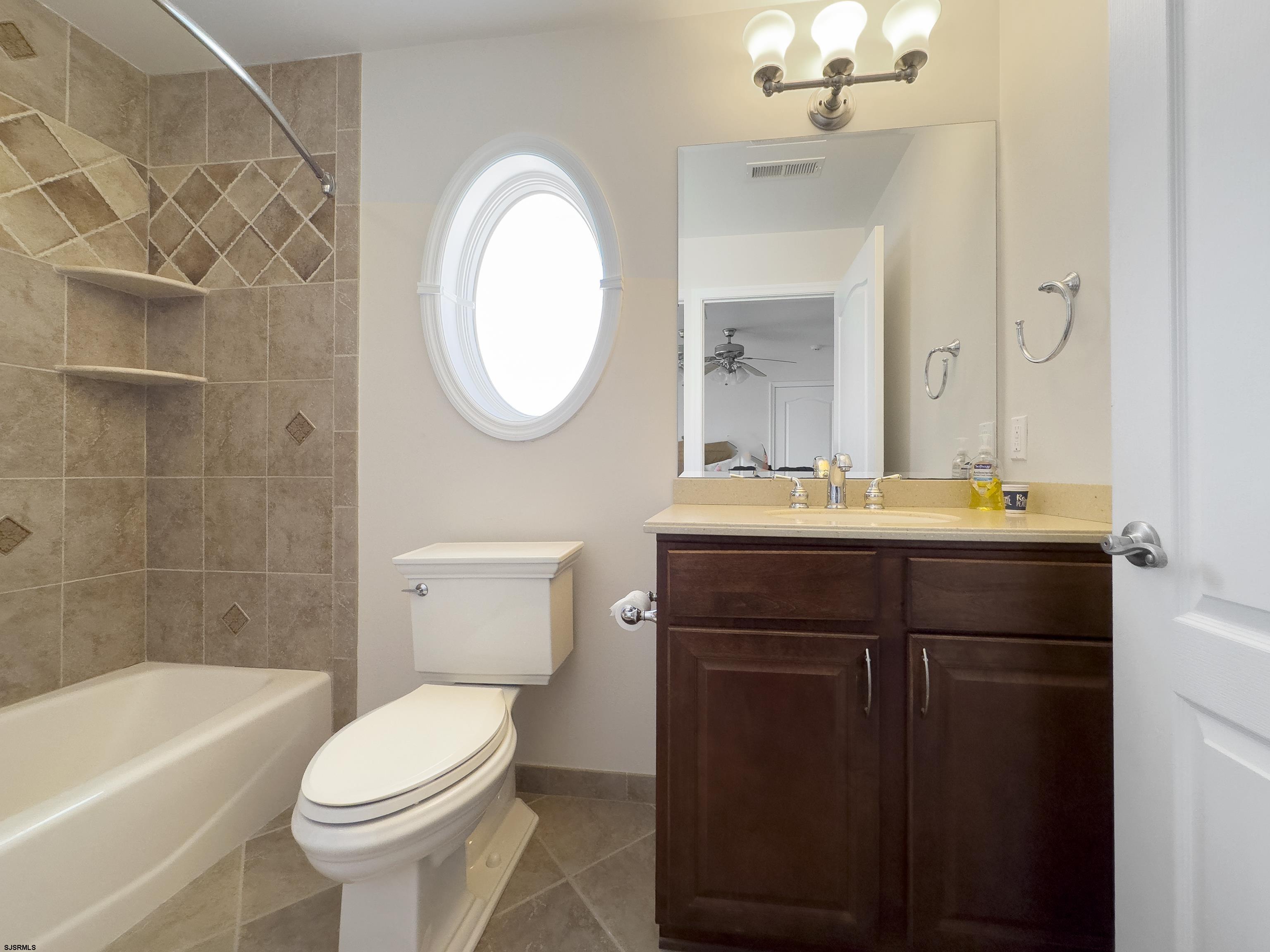 5219 Seaspray Road Brigantine, NJ 08203 - Photo 34 of 39 a bathroom with a sink a toilet and bathtub