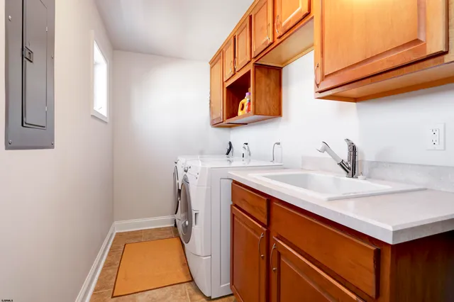 a utility room with a sink a washer and dryer