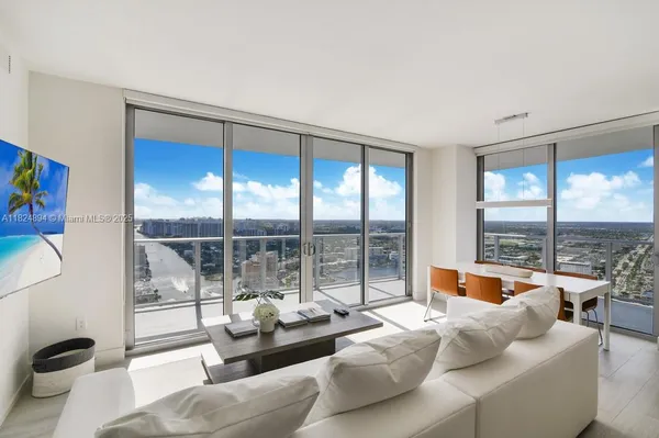 a living room with furniture and a large window