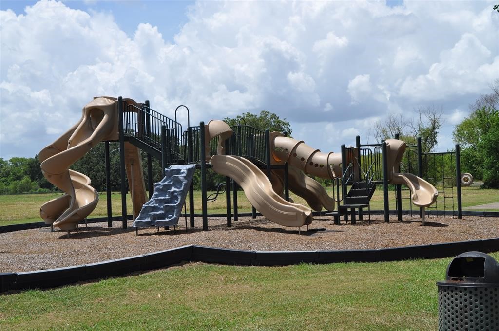 21210 Chenango Lake Drive Angleton, TX 77515 - Photo 9 of 15 a view of a park with swings and slides