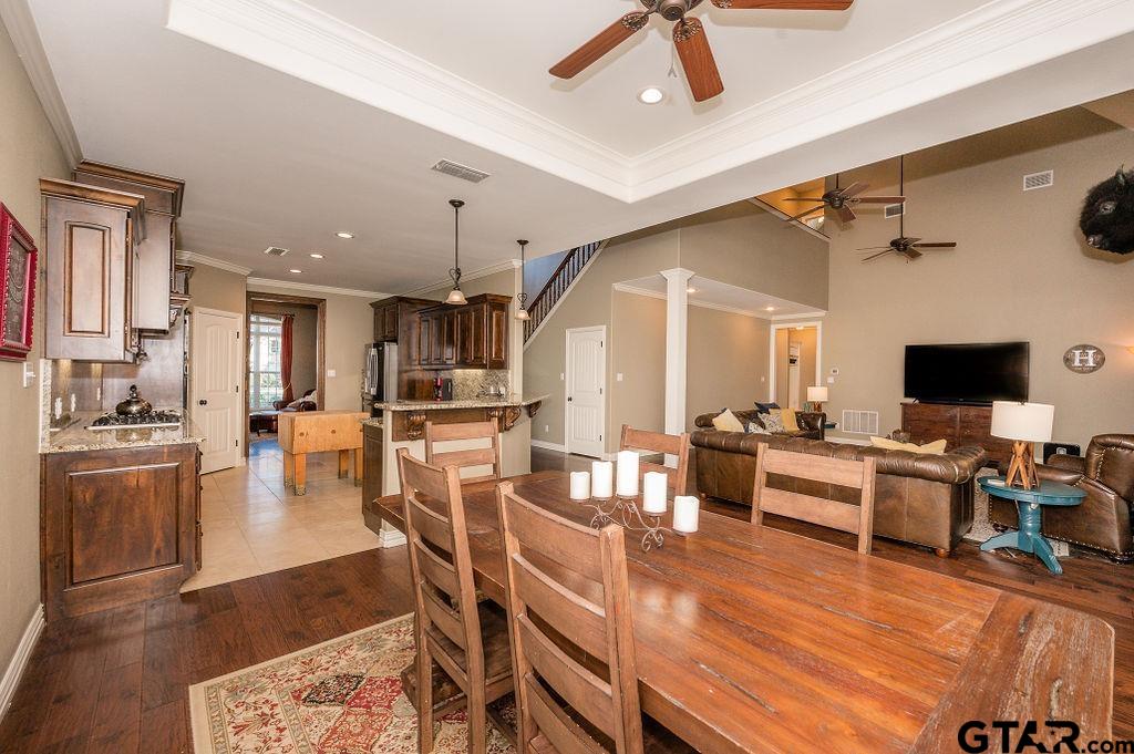 8553 Castleton Way Tyler, TX 75703 - Photo 11 of 38 a living room with furniture kitchen view and a wooden floor