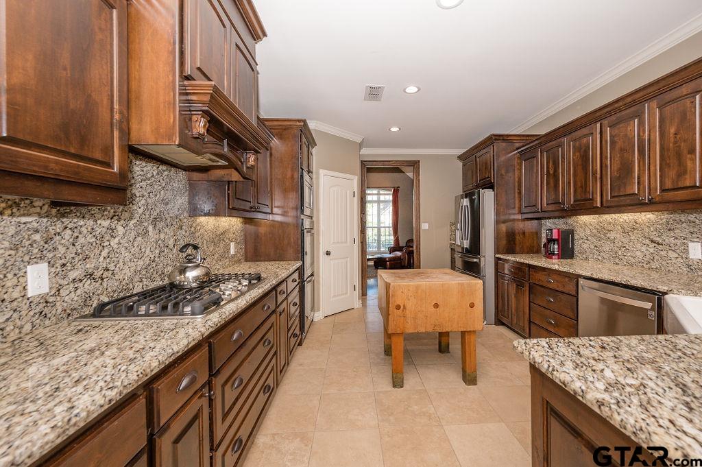 8553 Castleton Way Tyler, TX 75703 - Photo 12 of 38 a kitchen with stainless steel appliances granite countertop a stove top oven a sink dishwasher and cabinets with wooden floor