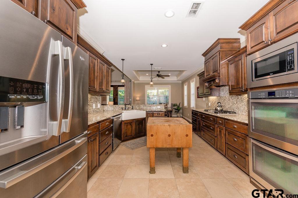 8553 Castleton Way Tyler, TX 75703 - Photo 14 of 38 a large kitchen with stainless steel appliances lots of counter space and breakfast area