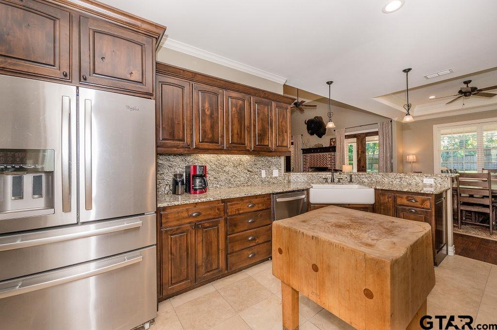 8553 Castleton Way Tyler, TX 75703 - Photo 15 of 38 a kitchen with stainless steel appliances granite countertop a refrigerator sink and cabinets