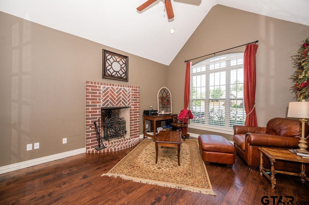 8553 Castleton Way Tyler, TX 75703 - Photo 16 of 38 a living room with furniture a rug and a fireplace
