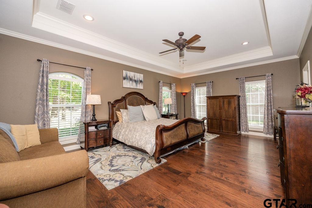 8553 Castleton Way Tyler, TX 75703 - Photo 19 of 38 a bedroom with a large bed and a couch