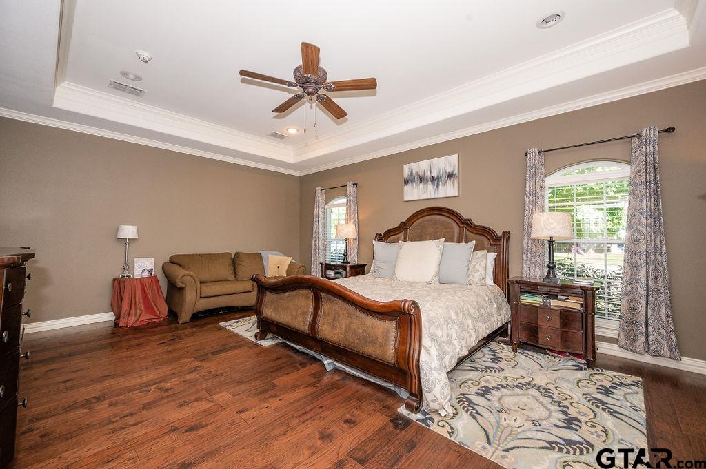 8553 Castleton Way Tyler, TX 75703 - Photo 20 of 38 a bedroom with a bed a mirror and a large window