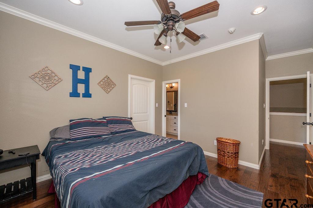 8553 Castleton Way Tyler, TX 75703 - Photo 29 of 38 a bedroom with a bed and a chandelier