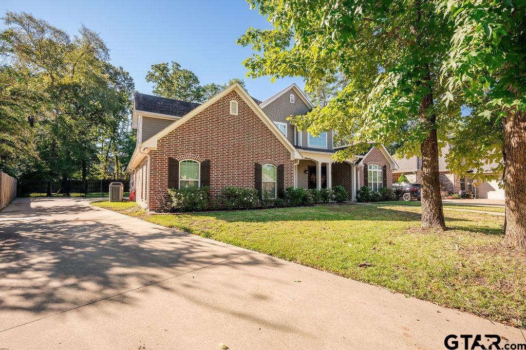 8553 Castleton Way Tyler, TX 75703 - Photo 3 of 38 a view of a yard in front of a house with large trees