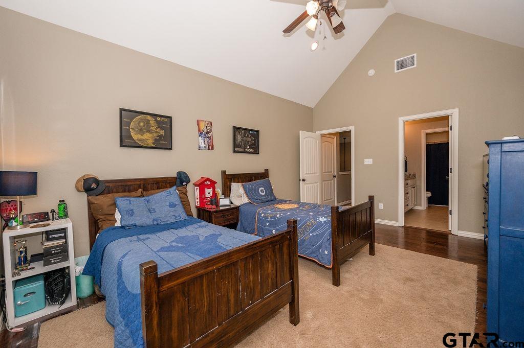 8553 Castleton Way Tyler, TX 75703 - Photo 32 of 38 a bed room with furniture and a chandelier