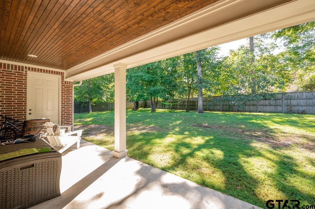 8553 Castleton Way Tyler, TX 75703 - Photo 33 of 38 a view of backyard with large trees and plants
