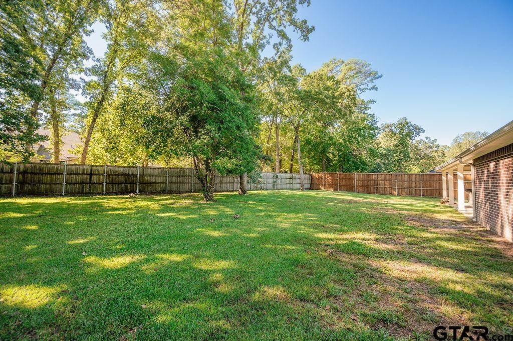 8553 Castleton Way Tyler, TX 75703 - Photo 38 of 38 a view of a yard with a large trees