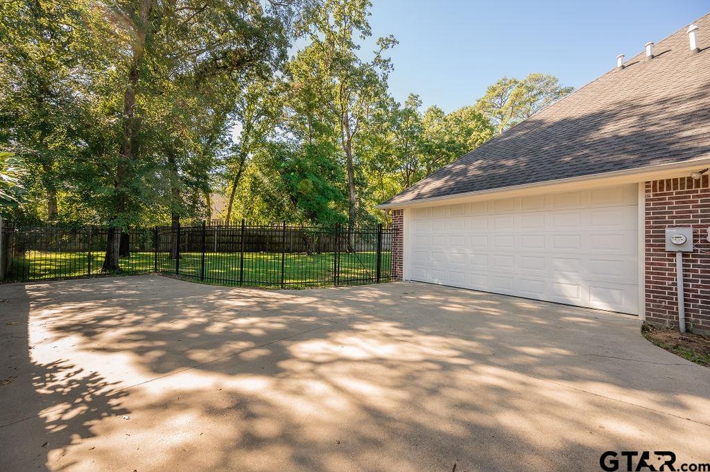 8553 Castleton Way Tyler, TX 75703 - Photo 4 of 38 a view of backyard and tree
