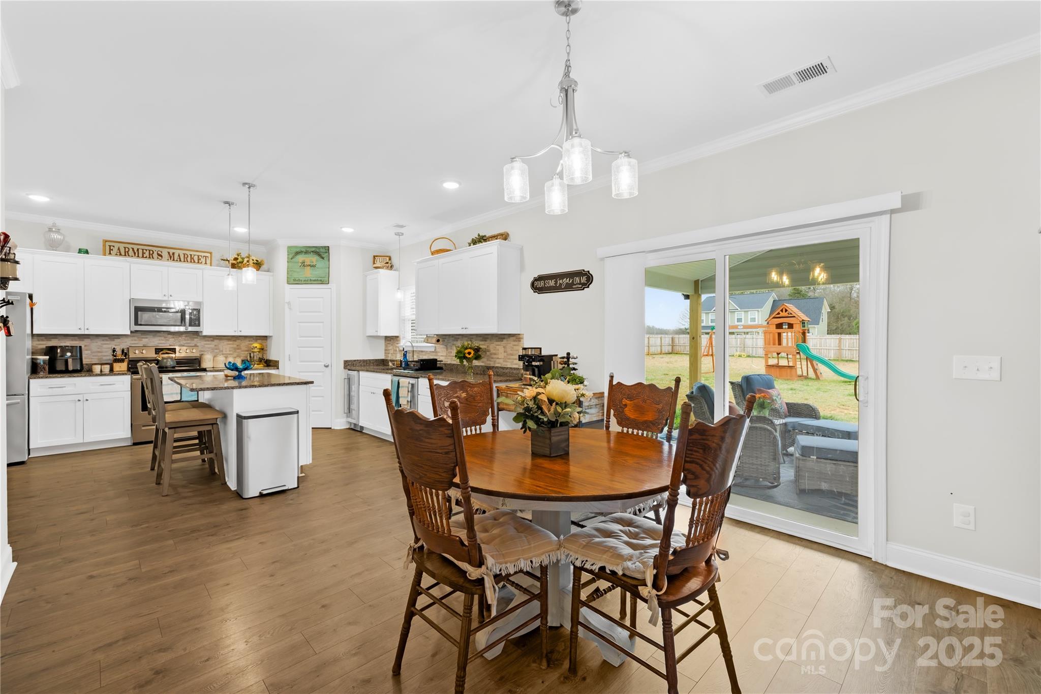 5405 Austin Road Monroe, NC 28112 - Photo 15 of 38 a view of a dining room with furniture and wooden floor