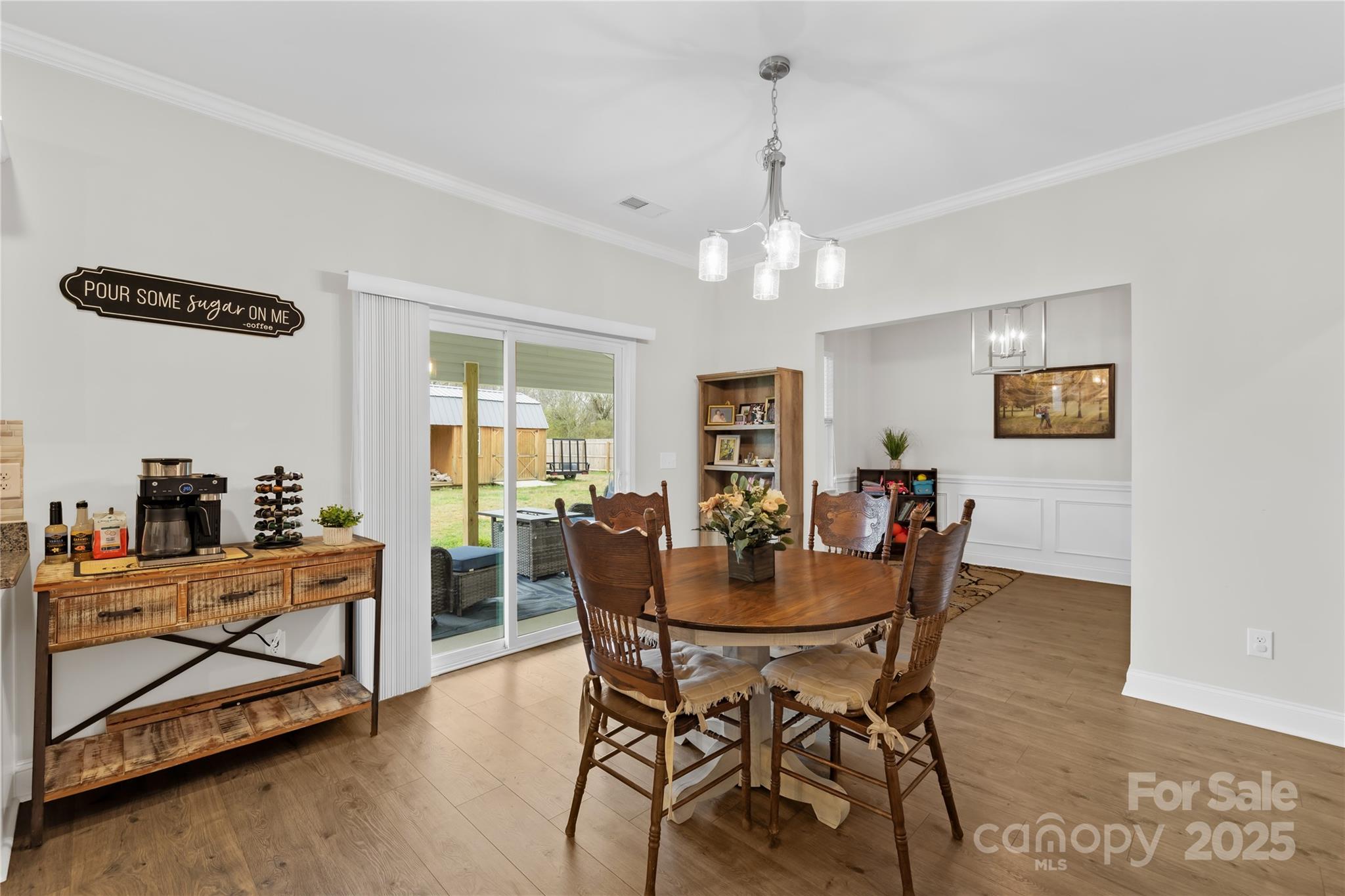 5405 Austin Road Monroe, NC 28112 - Photo 16 of 38 a dining room with furniture a chandelier and wooden floor